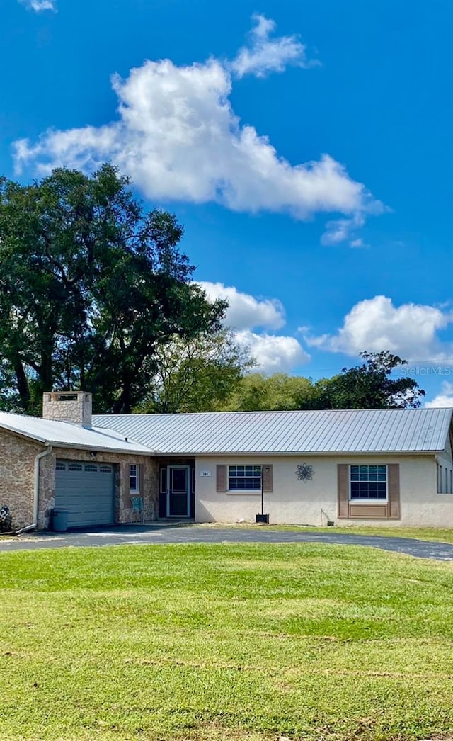 ranch-style house with a garage and a front yard