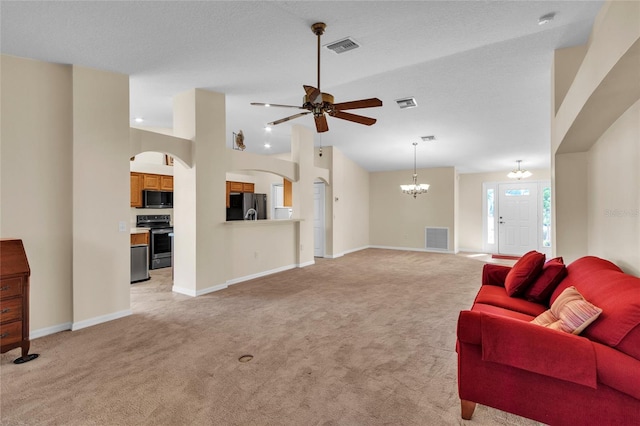 carpeted living room with high vaulted ceiling, a textured ceiling, and ceiling fan with notable chandelier