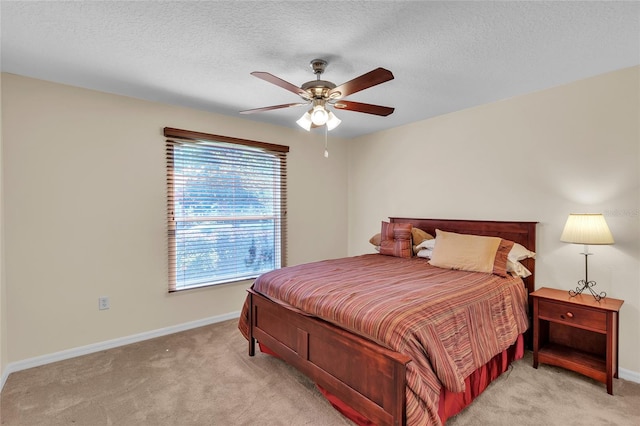 carpeted bedroom with a textured ceiling and ceiling fan