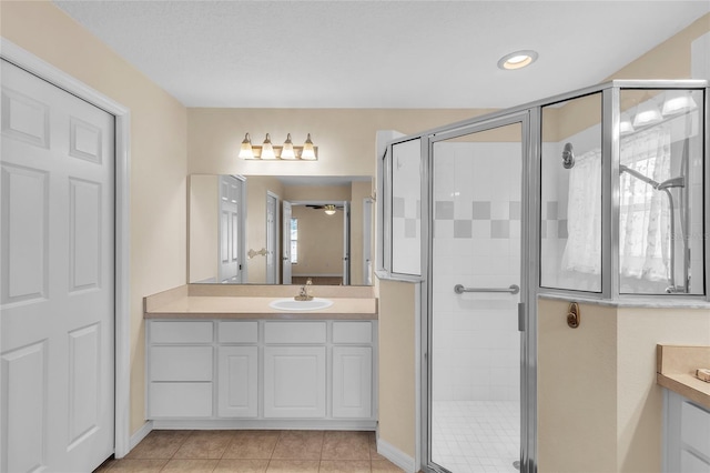 bathroom featuring vanity, walk in shower, and tile patterned flooring