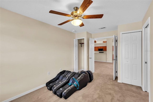 sitting room with light carpet and ceiling fan