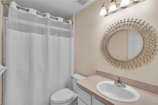 bathroom featuring toilet, a textured ceiling, a shower with curtain, and vanity