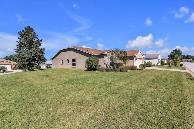 view of property exterior featuring a garage and a lawn