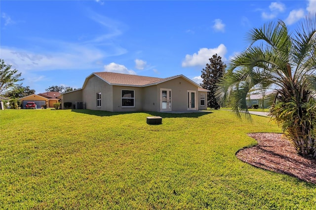 rear view of property with a yard