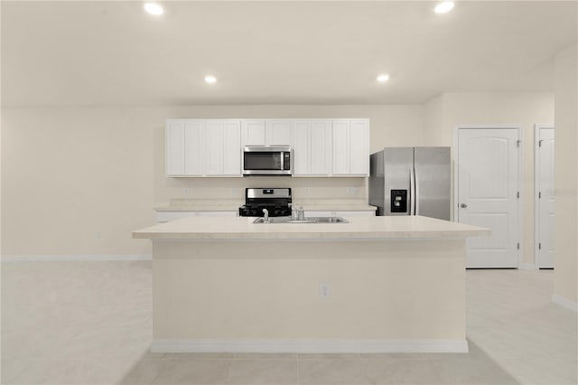 kitchen featuring white cabinetry, appliances with stainless steel finishes, an island with sink, and light tile patterned floors