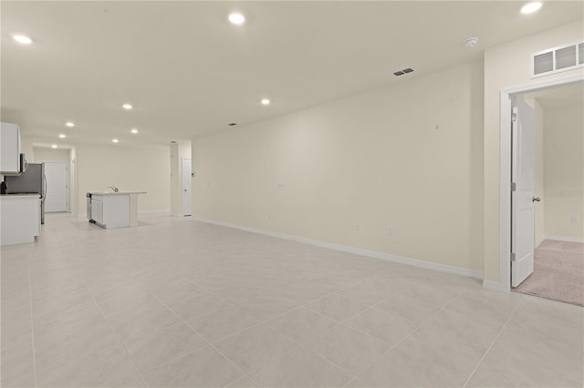 unfurnished living room with light tile patterned floors