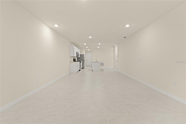 unfurnished living room featuring light tile patterned flooring