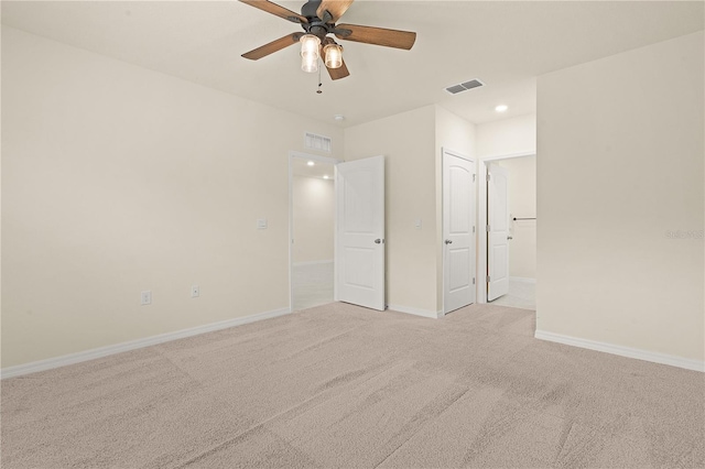 unfurnished bedroom with light colored carpet and ceiling fan