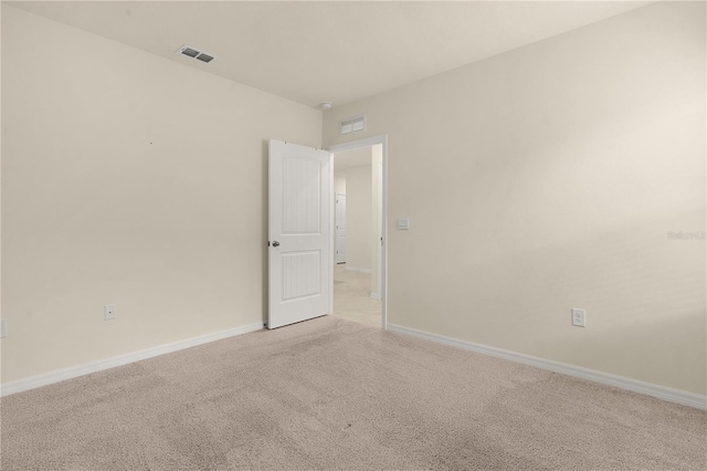 spare room with light colored carpet