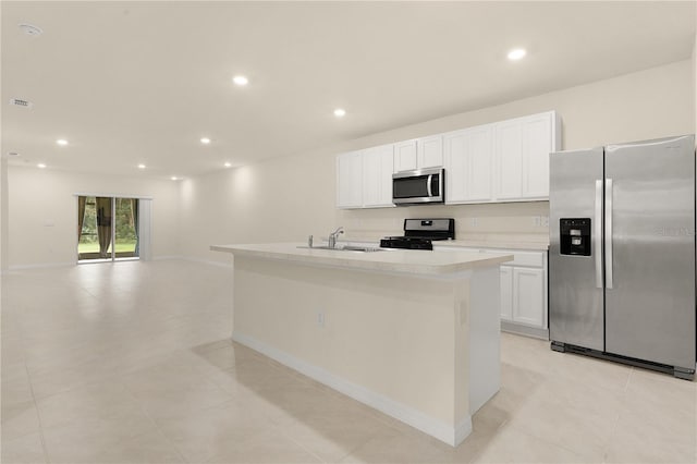 kitchen with sink, stainless steel appliances, white cabinets, and a center island with sink