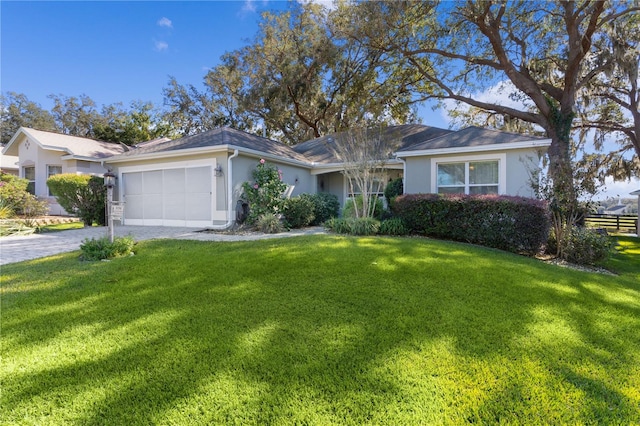 ranch-style house featuring a garage and a front lawn