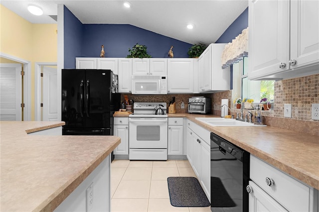 kitchen featuring white cabinetry, black appliances, lofted ceiling, and sink