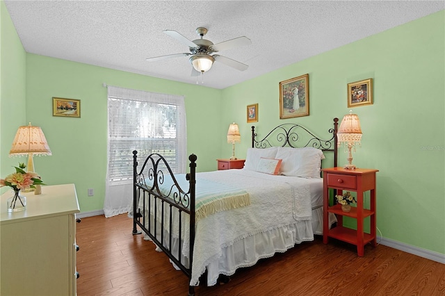 bedroom with ceiling fan, a textured ceiling, and hardwood / wood-style floors