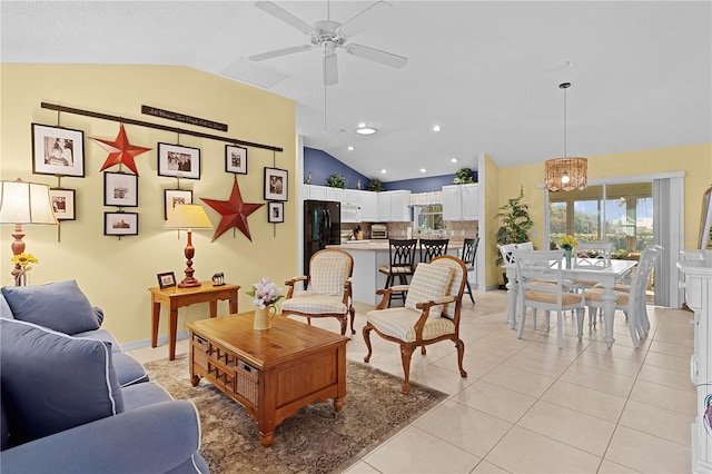 living room featuring light tile patterned floors, vaulted ceiling, and ceiling fan with notable chandelier