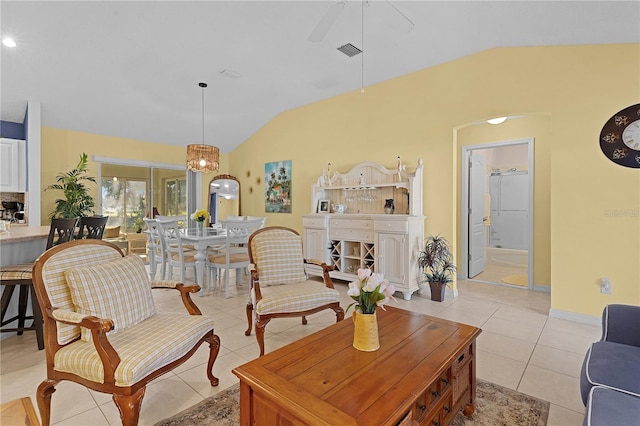 tiled living room with vaulted ceiling and ceiling fan