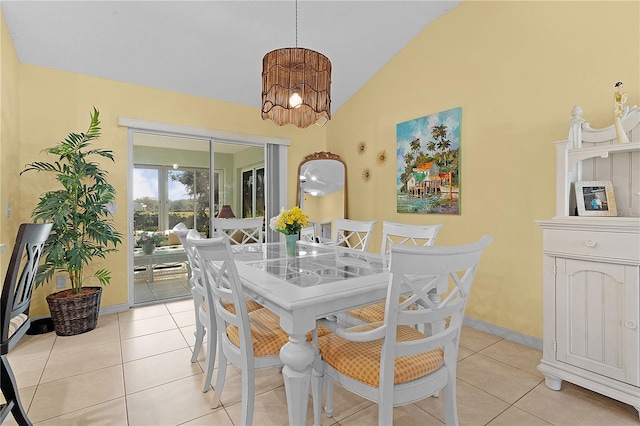 dining room with lofted ceiling and light tile patterned flooring