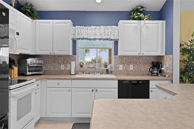 kitchen featuring white appliances, light tile patterned flooring, white cabinetry, and sink