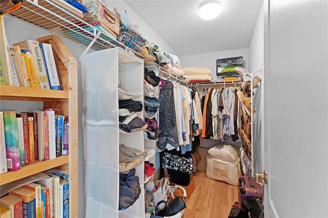 walk in closet with wood-type flooring