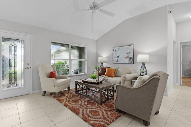 living area with light tile patterned flooring, a healthy amount of sunlight, lofted ceiling, and ceiling fan