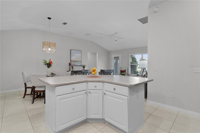 kitchen with visible vents, light countertops, lofted ceiling, light tile patterned floors, and a ceiling fan