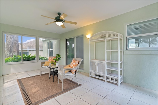 sunroom featuring ceiling fan