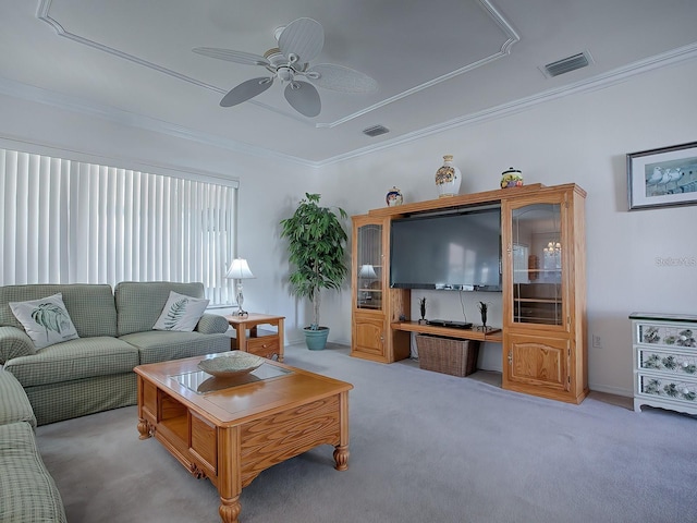 living room with ornamental molding, light colored carpet, and ceiling fan