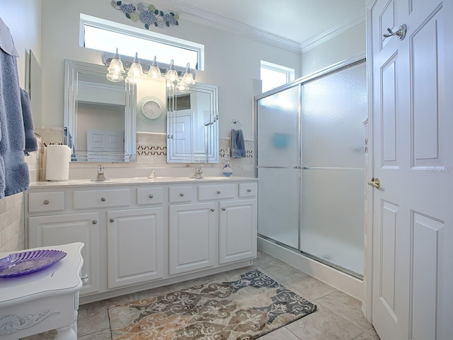 bathroom featuring tile patterned flooring, a shower with shower door, crown molding, vanity, and tasteful backsplash