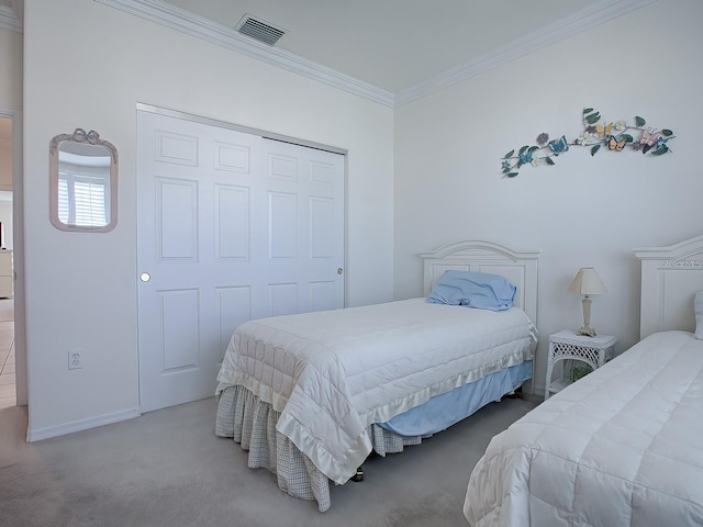 bedroom featuring a closet, ornamental molding, and carpet flooring