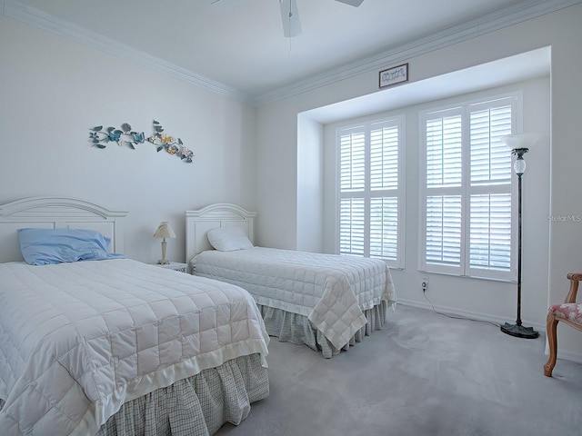 carpeted bedroom featuring ornamental molding and ceiling fan