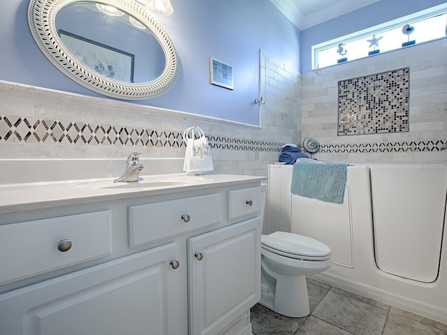 bathroom with a washtub, toilet, tile walls, vanity, and ornamental molding