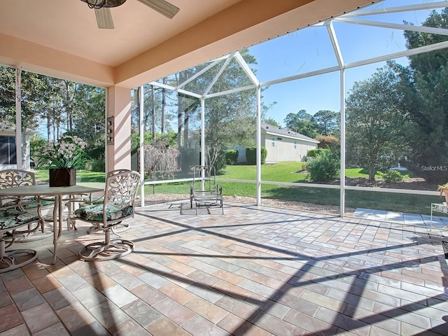 unfurnished sunroom with ceiling fan