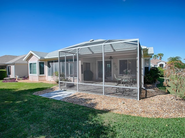 rear view of house featuring a yard, a patio area, a lanai, and ceiling fan