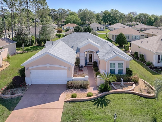 view of front facade with a front yard and a garage