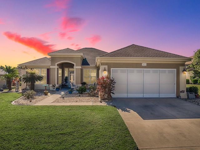 view of front of house featuring a lawn and a garage