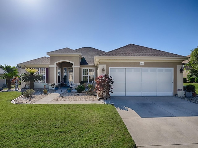 view of front of property with a front lawn and a garage