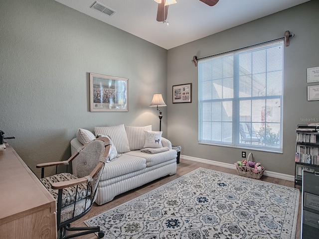 living room featuring ceiling fan, hardwood / wood-style flooring, and a wealth of natural light