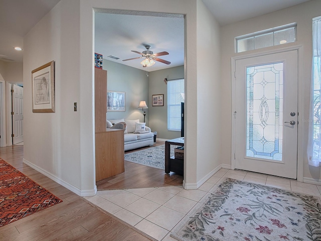 foyer with light hardwood / wood-style floors, a healthy amount of sunlight, and ceiling fan