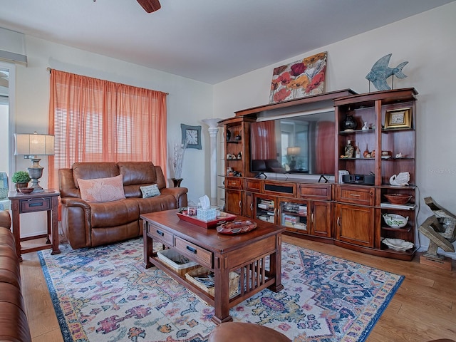 living room with light wood-type flooring and ceiling fan