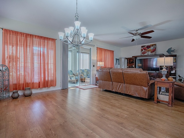 living room featuring light hardwood / wood-style floors and ceiling fan with notable chandelier