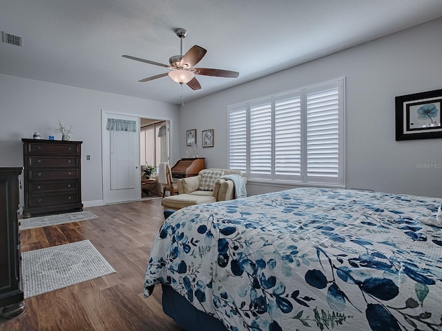 bedroom with a closet, wood-type flooring, and ceiling fan