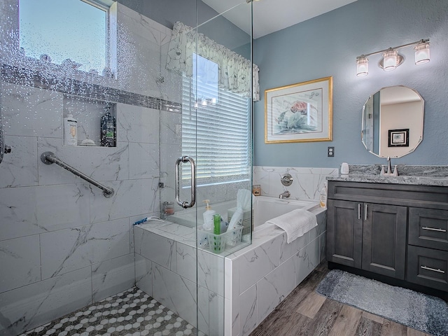 bathroom with vanity, independent shower and bath, and hardwood / wood-style flooring