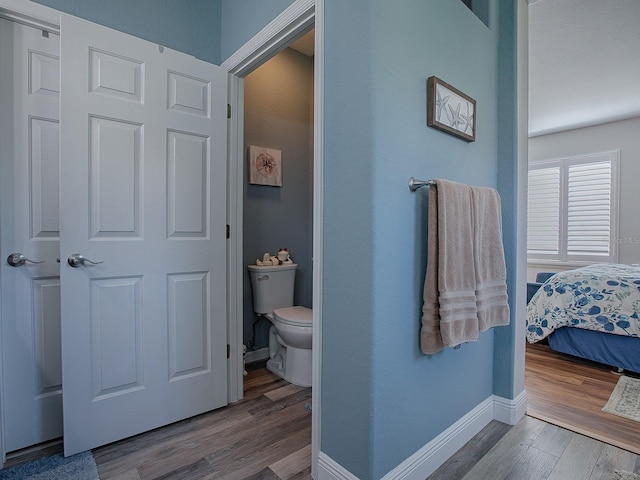 bathroom featuring hardwood / wood-style floors and toilet