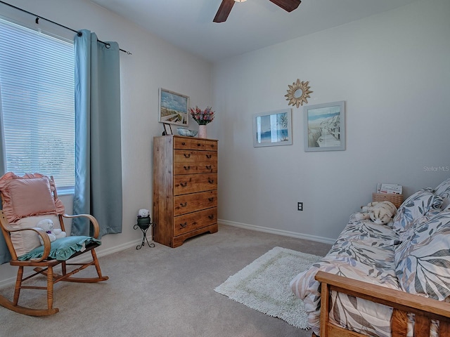 living area with ceiling fan, light carpet, and a wealth of natural light