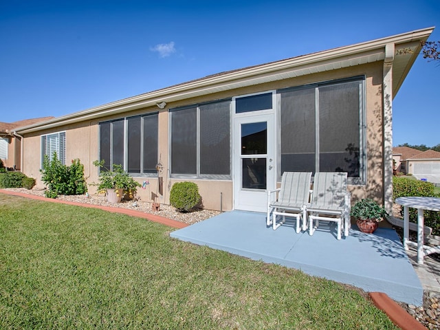 rear view of house featuring a patio and a lawn