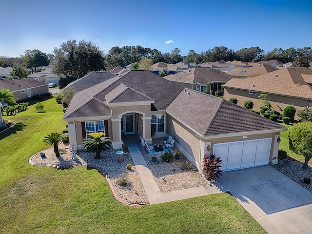 view of front of property featuring a front yard and a garage