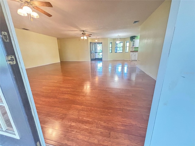 spare room with hardwood / wood-style flooring and ceiling fan