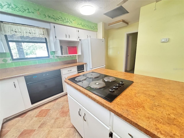 kitchen with white cabinetry, tasteful backsplash, black electric cooktop, and white refrigerator