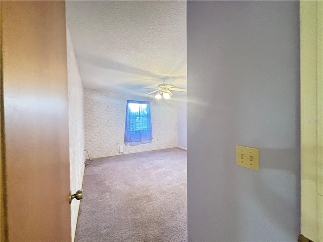 interior space featuring ceiling fan and a textured ceiling