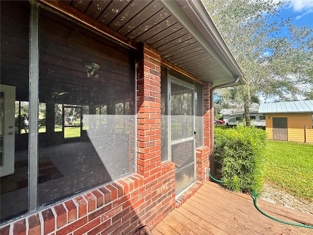 wooden deck featuring a lawn