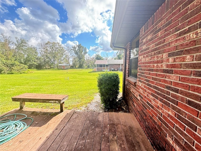 wooden terrace with a lawn